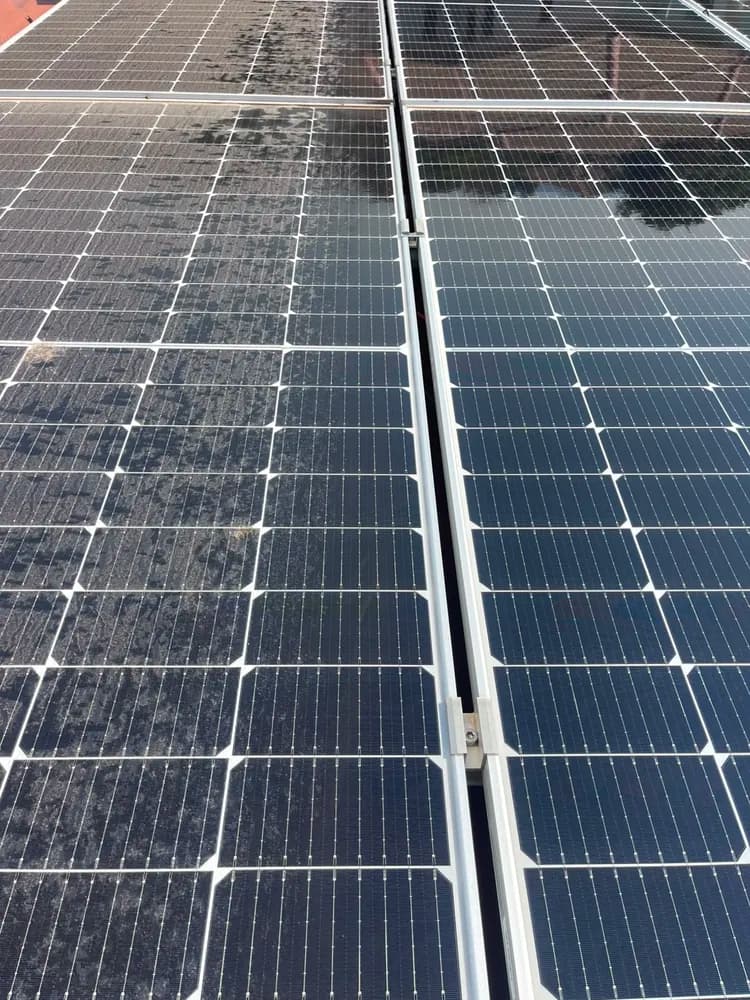 Dirty and freshly cleaned solar panels side by side on a Pretoria roof
